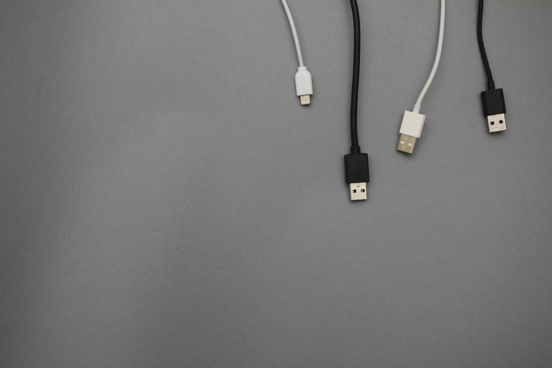 various charging cable ends on a grey background