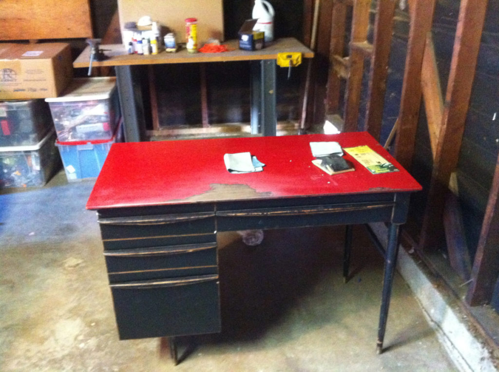 A badly painted desk in a garage