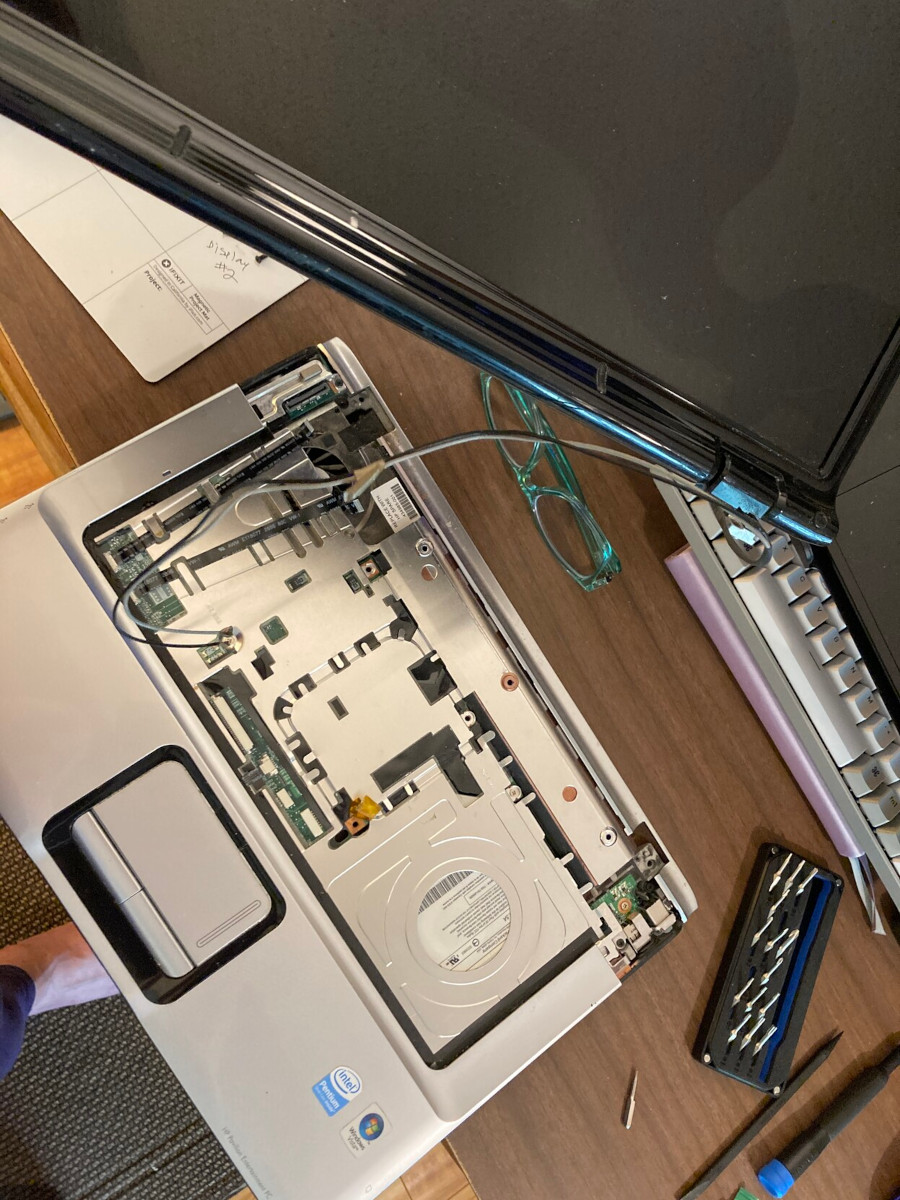 Photo of an HP laptop with display being removed