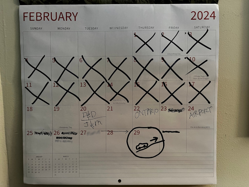 February calendar page with dates marked off.