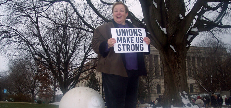 Person holding sign that says, "Unions make us strong."